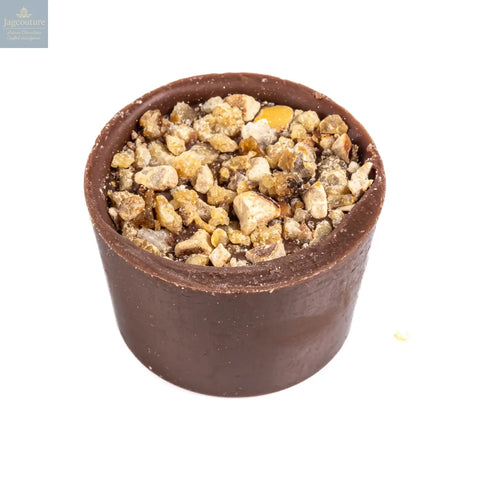 Butter caramel - smooth butter caramel in a milk chocolate cup topped with roasted hazelnuts 13.7g - Jag Couture Chocolates