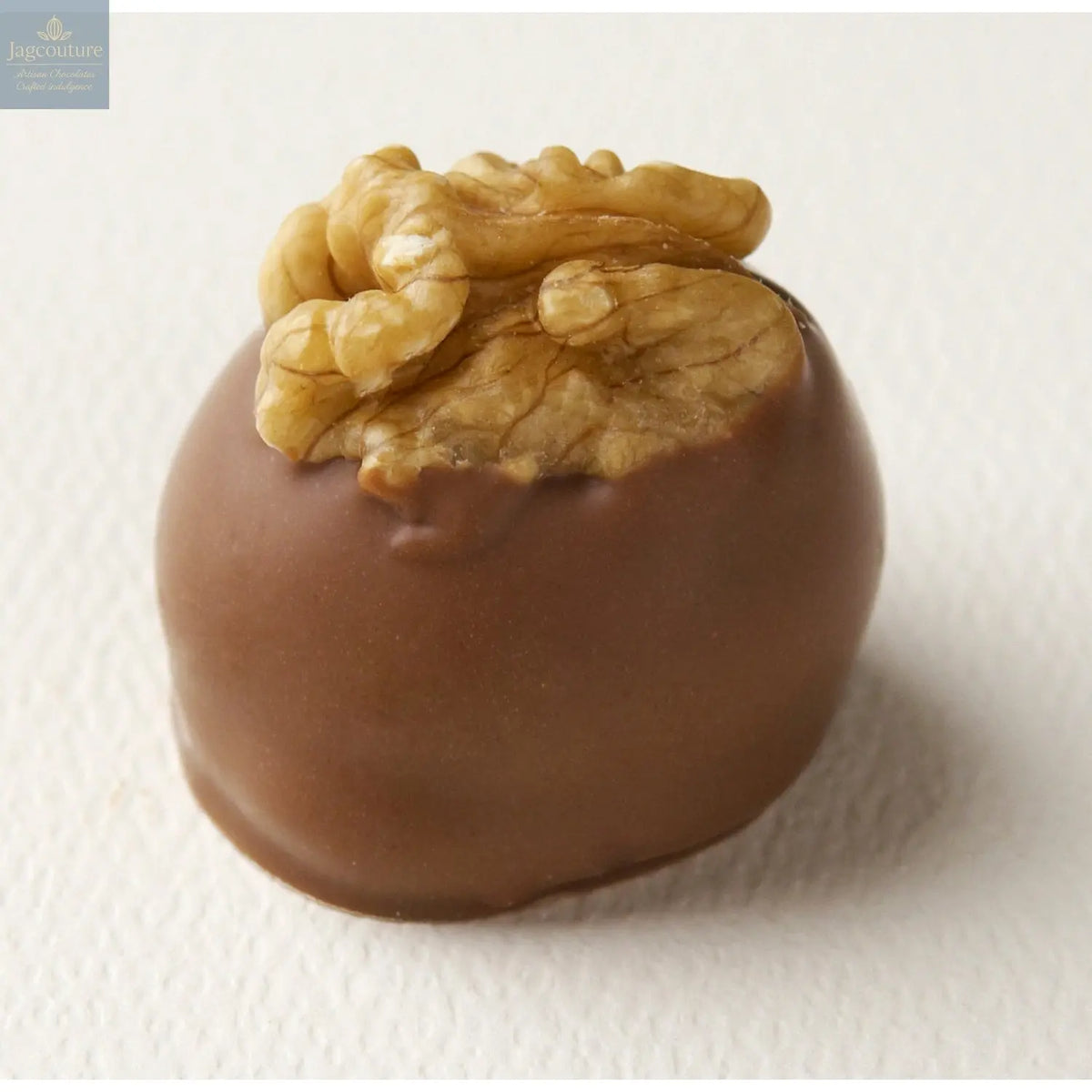 Manon Lait - light hazelnut caramel mousse on a croquant base hand decorated with a walnut 19g - Jag Couture Chocolates
