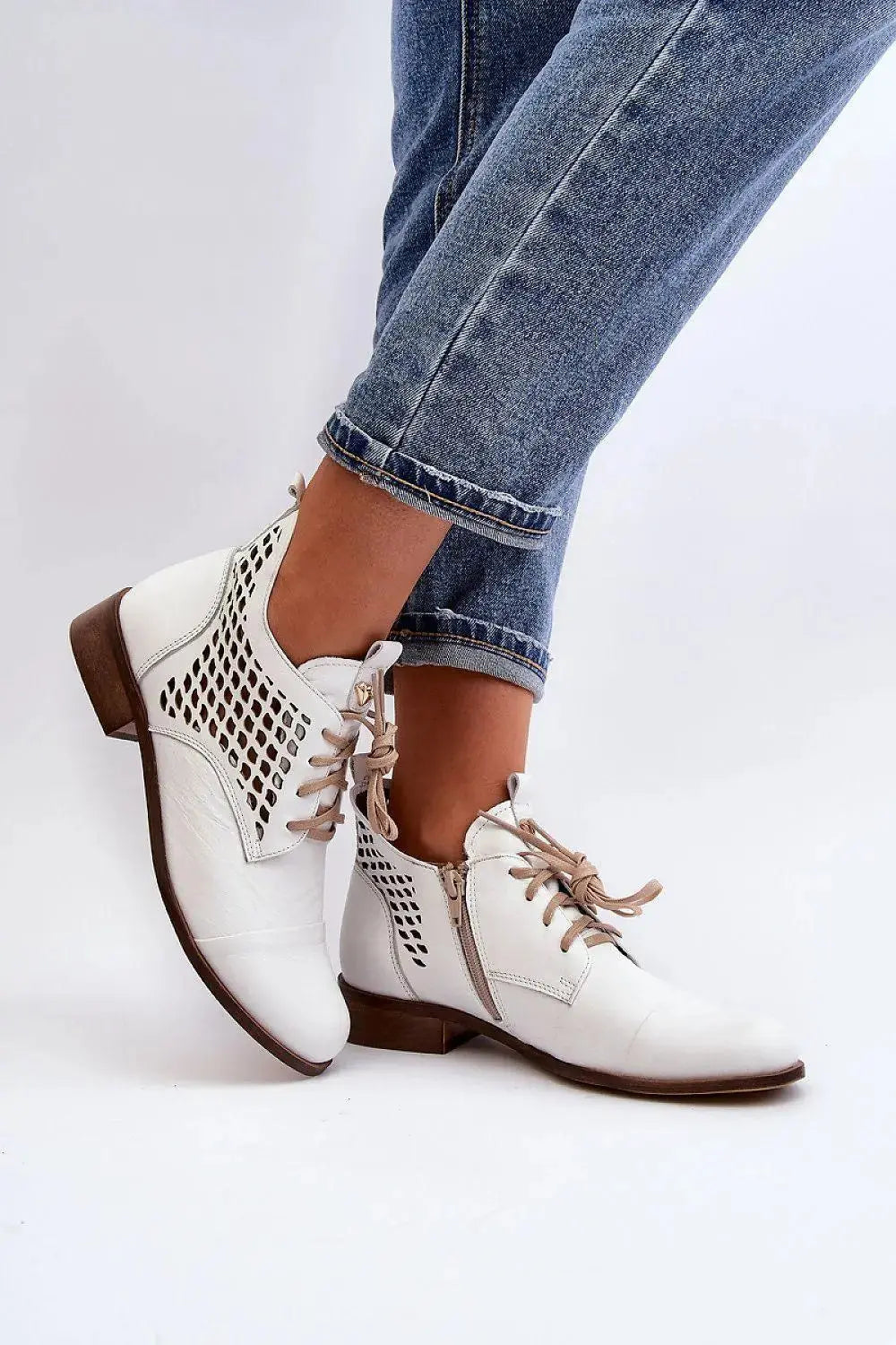 Step in style Women's natural suede boots with a low, openwork.