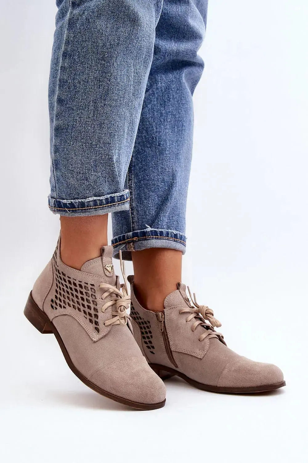 Step in style Women's natural suede boots with a low, openwork.